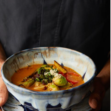 Bowl of soupy ramen topped with vegetables at Izumi in Bandra