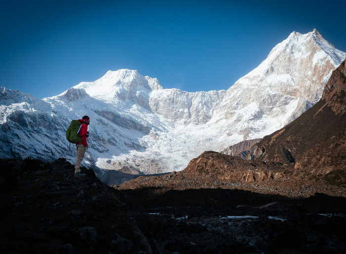 A mountaineer standing in front of a mountain