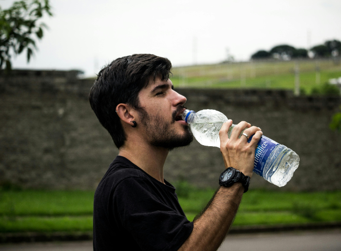 Person drinking bottled water